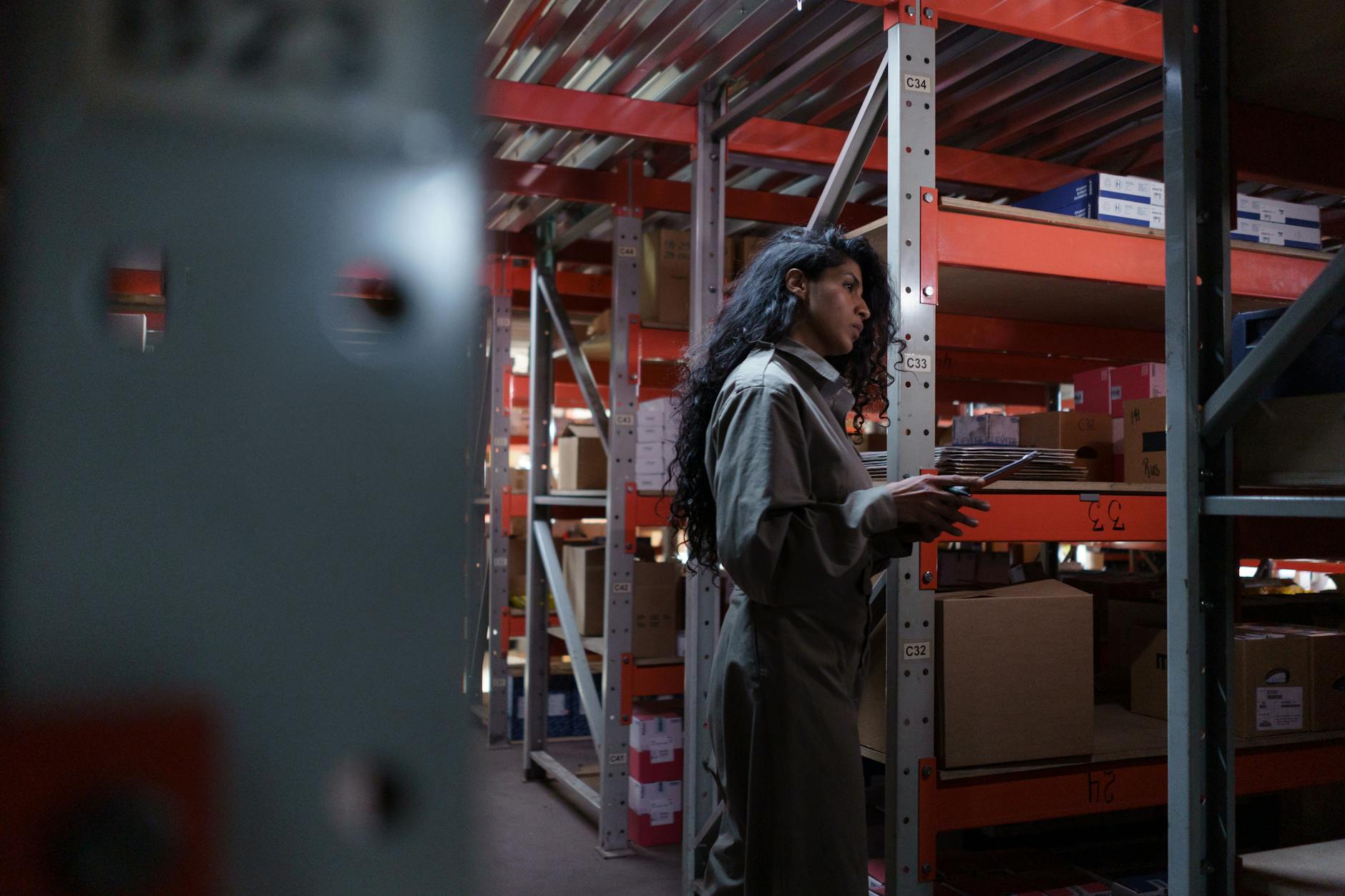 ai for inventory management worker checking warehouse stock